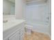 Well-lit bathroom with a shower-tub combo and a classic vanity with storage at 169 Holly Ct, Loganville, GA 30052