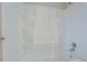 Clean white bathtub and shower combination features built-in shelving for toiletries at 169 Holly Ct, Loganville, GA 30052