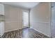 Bright dining area featuring stylish wood-look flooring and a glass door for natural light at 169 Holly Ct, Loganville, GA 30052
