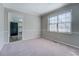 Dining room with a large window allowing natural light with a view into the kitchen at 169 Holly Ct, Loganville, GA 30052