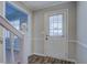 Welcoming foyer featuring a staircase and a front door with sidelight for natural lighting at 169 Holly Ct, Loganville, GA 30052