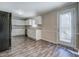 Bright kitchen with white cabinets, modern appliances, and vinyl floors at 169 Holly Ct, Loganville, GA 30052