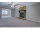 Open-concept living room featuring a stone fireplace and seamlessly connects to other living spaces at 169 Holly Ct, Loganville, GA 30052