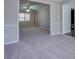 Spacious living room with carpet flooring and access to another room at 169 Holly Ct, Loganville, GA 30052