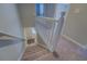 Carpeted staircase with white railing, leading to upper and lower levels at 169 Holly Ct, Loganville, GA 30052