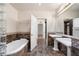Bathroom with a soaking tub, tiled walls, double sinks, and a walk-in closet at 5300 Brooke Ridge Dr, Dunwoody, GA 30338