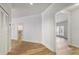 Hallway with wood flooring, white walls and trim, and doors leading to other rooms at 5300 Brooke Ridge Dr, Dunwoody, GA 30338