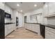 Bright kitchen boasts white cabinets, stainless steel appliances, granite counters, and wood floors at 5300 Brooke Ridge Dr, Dunwoody, GA 30338