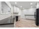 Kitchen showcases white cabinets, stainless steel appliances, granite counters, and light wood floors at 5300 Brooke Ridge Dr, Dunwoody, GA 30338