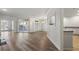 Open living room with hardwood floors, access to a balcony, and a view into an eat-in kitchen area at 5300 Brooke Ridge Dr, Dunwoody, GA 30338