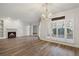 Bright living room features wood floors, a fireplace, plantation shutters, and views of the greenery outside at 5300 Brooke Ridge Dr, Atlanta, GA 30338