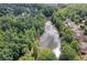 Scenic aerial view of lake surrounded by trees and residential properties at 672 Red Sunset Cir, Powder Springs, GA 30127