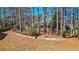 Spacious backyard features trees, a zipline, and a retaining wall with garden bed at 672 Red Sunset Cir, Powder Springs, GA 30127