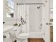 Charming bathroom with a shower-tub combo featuring stylish bronze hardware and decorative shower curtain at 672 Red Sunset Cir, Powder Springs, GA 30127