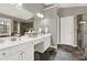 Bathroom featuring a double sink vanity with white cabinetry and unique stone tile flooring at 672 Red Sunset Cir, Powder Springs, GA 30127