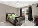 Bedroom with a gray wall, a bed, a ceiling fan and a window with black curtains at 672 Red Sunset Cir, Powder Springs, GA 30127