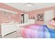 Charming bedroom featuring a colorful decor, white furniture, and ample natural light at 672 Red Sunset Cir, Powder Springs, GA 30127