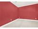 Bedroom with neutral carpeting, baseboard trim, and a bold red paint at 672 Red Sunset Cir, Powder Springs, GA 30127
