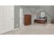 Bedroom with neutral colored carpet and walls and a traditional style dresser and decor at 672 Red Sunset Cir, Powder Springs, GA 30127