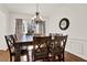 Elegant dining room with a wooden table, seating for six, and a view of the front yard at 672 Red Sunset Cir, Powder Springs, GA 30127