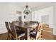 Dining room showcases a large wooden table with seating for eight and hardwood floors at 672 Red Sunset Cir, Powder Springs, GA 30127