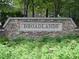 Stone monument sign for Broadlands neighborhood with mature plants in front at 672 Red Sunset Cir, Powder Springs, GA 30127
