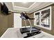 Exercise room featuring a treadmill, natural light, and a mounted television at 672 Red Sunset Cir, Powder Springs, GA 30127