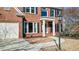 Attractive brick home with a welcoming front porch and well-maintained landscaping at 672 Red Sunset Cir, Powder Springs, GA 30127