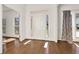 Sun-drenched foyer with gleaming hardwood floors and neutral decor at 672 Red Sunset Cir, Powder Springs, GA 30127