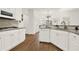Bright kitchen with white cabinetry, granite countertops, and stainless steel appliances at 672 Red Sunset Cir, Powder Springs, GA 30127