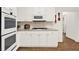 Kitchen with double wall oven, gas cooktop, white cabinets, and granite countertops at 672 Red Sunset Cir, Powder Springs, GA 30127
