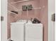 Laundry room with a washer and dryer and storage shelves at 672 Red Sunset Cir, Powder Springs, GA 30127