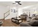 Spacious living room with hardwood floors, stairs and comfortable seating at 672 Red Sunset Cir, Powder Springs, GA 30127