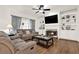 Comfortable living room with a fireplace, built-in shelving, and hardwood floors at 672 Red Sunset Cir, Powder Springs, GA 30127