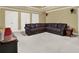 Spacious living room with neutral carpet and a comfortable sectional sofa at 672 Red Sunset Cir, Powder Springs, GA 30127