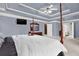 Spacious primary bedroom with access to an ensuite bathroom, featuring a large bed at 672 Red Sunset Cir, Powder Springs, GA 30127