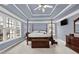 Spacious main bedroom features a tray ceiling, large windows and dark wood furniture at 672 Red Sunset Cir, Powder Springs, GA 30127