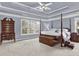 Spacious primary bedroom with coffered ceiling and elegant wooden furniture at 672 Red Sunset Cir, Powder Springs, GA 30127