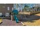Backyard playground features a slide, climbing wall, and swings for Gathering fun at 672 Red Sunset Cir, Powder Springs, GA 30127