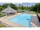 Community pool with large swimming area, pool house, and ample lounging space at 672 Red Sunset Cir, Powder Springs, GA 30127