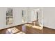 Sunlit room with pristine hardwood floors, white walls, and elegant French doors at 672 Red Sunset Cir, Powder Springs, GA 30127