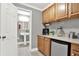 Convenient wet bar area featuring a sink, mini-fridge, and cabinet storage at 672 Red Sunset Cir, Powder Springs, GA 30127