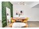 Bright dining area featuring a wood table, yellow chairs, a bench with a white furry cover, and unique wall decor at 680 Greenwood Ne Ave # 202, Atlanta, GA 30306