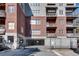 Multi-story condo building displaying brick and gray stone facade, secure parking and multiple balconies at 680 Greenwood Ne Ave # 202, Atlanta, GA 30306