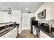 Contemporary kitchen featuring stainless steel appliances, granite countertops, and white cabinetry at 680 Greenwood Ne Ave # 202, Atlanta, GA 30306