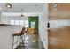 A long-shot interior view of a living room featuring a dining area and bar seating with modern lighting at 680 Greenwood Ne Ave # 202, Atlanta, GA 30306