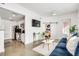 Inviting living room featuring a comfortable blue sofa next to a kitchen and a sliding barn door at 680 Greenwood Ne Ave # 202, Atlanta, GA 30306