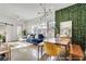 Open-concept living area with blue sofa, dining set, stylish lighting, and leafy green wall for a unique modern design at 680 Greenwood Ne Ave # 202, Atlanta, GA 30306