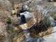 Aerial view of a home showcasing its mature trees and paved driveway on a sunny day at 940 Highview Se Dr, Smyrna, GA 30082