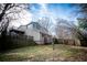 Spacious backyard with a two-story home, featuring a fenced yard and a deck overlooking the grounds at 940 Highview Se Dr, Smyrna, GA 30082